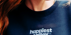 https://bonafidephoto.com Photo of @happyvalleyhannah smiling while wearing navy crew neck sweater with white embroidered logo 'happiest valley.' Perfect for Penn State fans and nostalgia for good times in happy valley / State College, PA