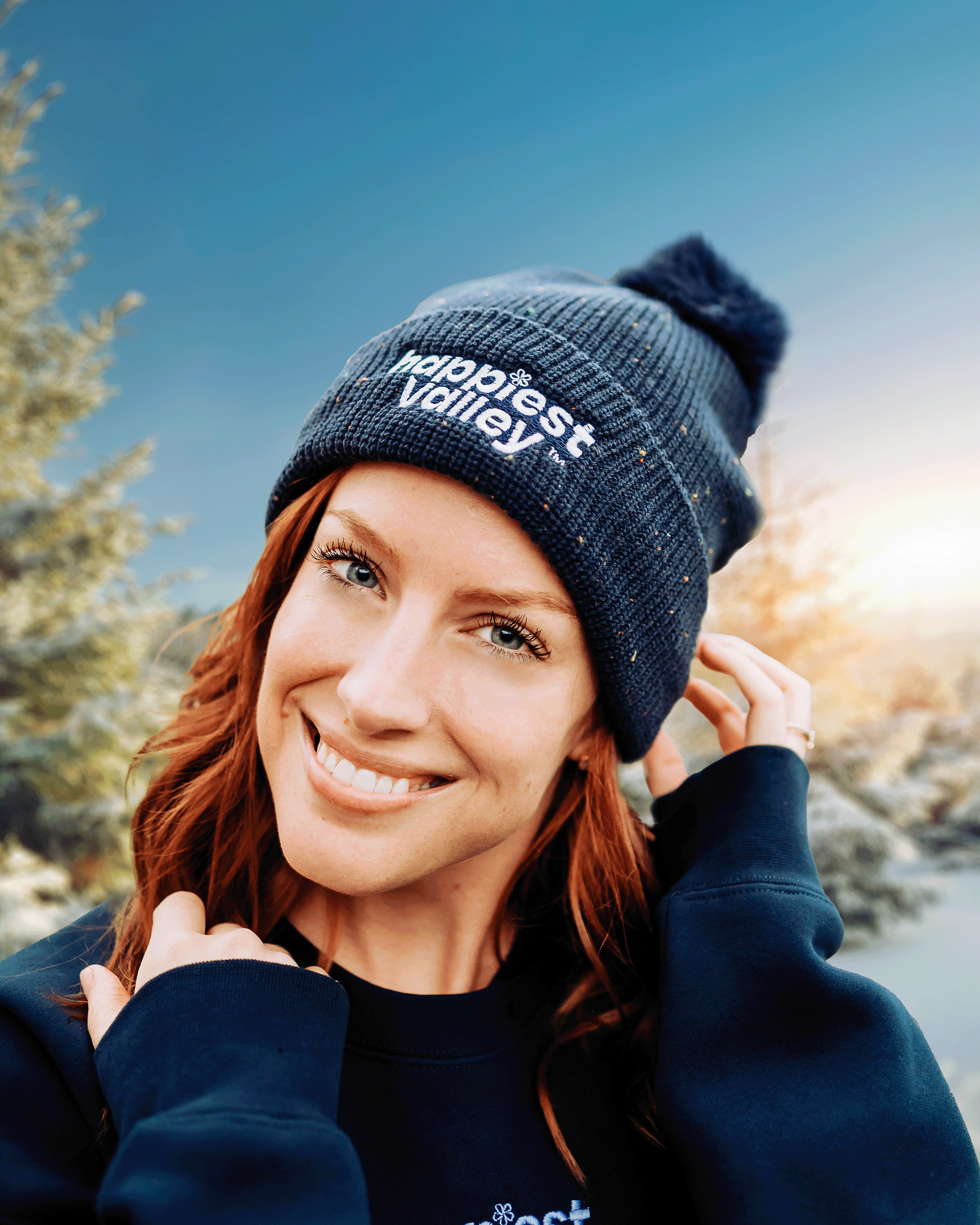 https://bonafidephoto.com Photo of @happyvalleyhannah smiling while wearing navy speckled beanie with white embroidered logo 'happiest valley.' Perfect for Penn State fans winter wear, staying cozy, and nostalgia for good times in happy valley / State College, PA