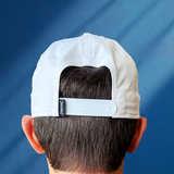 @happyvalleyhannah's husband Paul wearing White baseball hat / baseball cap with navy embroidered logo 'happiest valley' and navy cord. Back view showing a snapback adjustable sizing. Perfect for Penn State fans and nostalgia for good times in happy valley / State College, PA / casual and trending