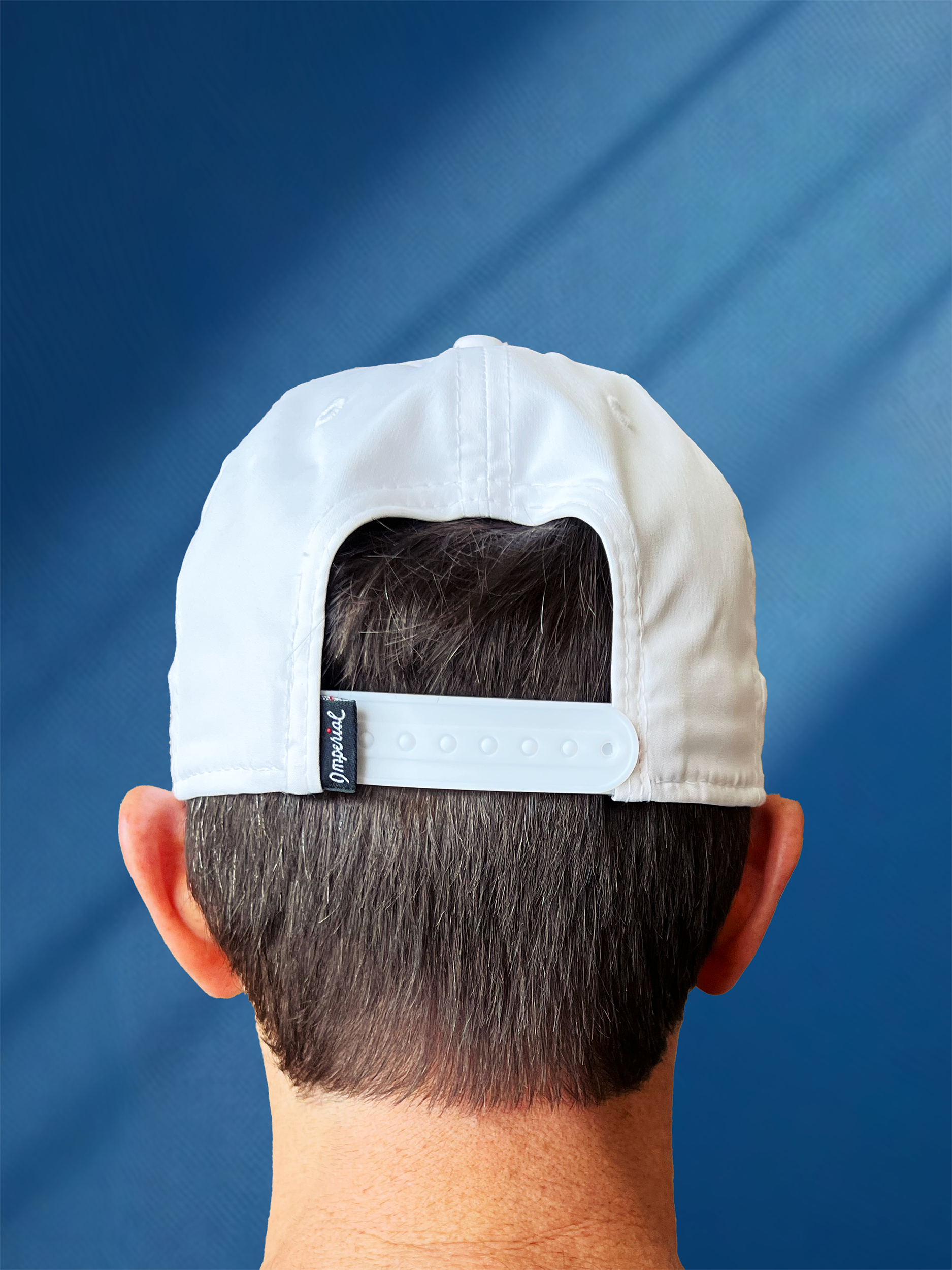 @happyvalleyhannah's husband Paul wearing White baseball hat / baseball cap with navy embroidered logo 'happiest valley' and navy cord. Back view showing a snapback adjustable sizing. Perfect for Penn State fans and nostalgia for good times in happy valley / State College, PA / casual and trending